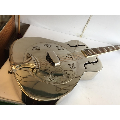 286 - Antoria Brass Bodied Resonator Guitar with 2 Bottle Necks.
In Lovely Condition and with Case.
Shippi... 