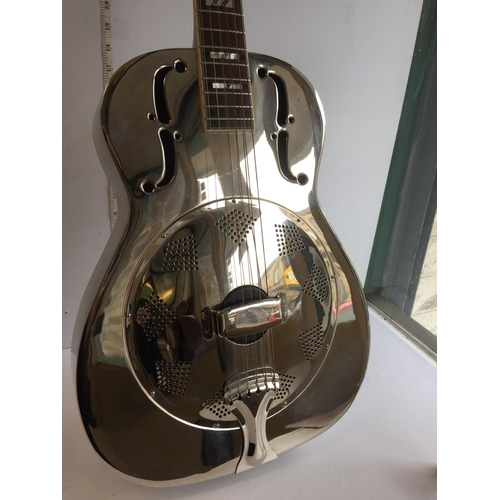 286 - Antoria Brass Bodied Resonator Guitar with 2 Bottle Necks.
In Lovely Condition and with Case.
Shippi... 