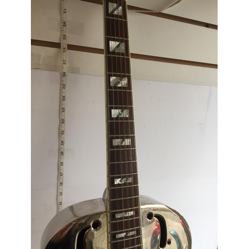 286 - Antoria Brass Bodied Resonator Guitar with 2 Bottle Necks.
In Lovely Condition and with Case.
Shippi... 