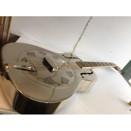 286 - Antoria Brass Bodied Resonator Guitar with 2 Bottle Necks.
In Lovely Condition and with Case.
Shippi... 