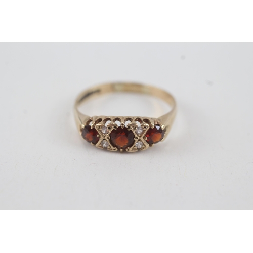 24 - 9ct gold garnet & white gemstone seven stone ring