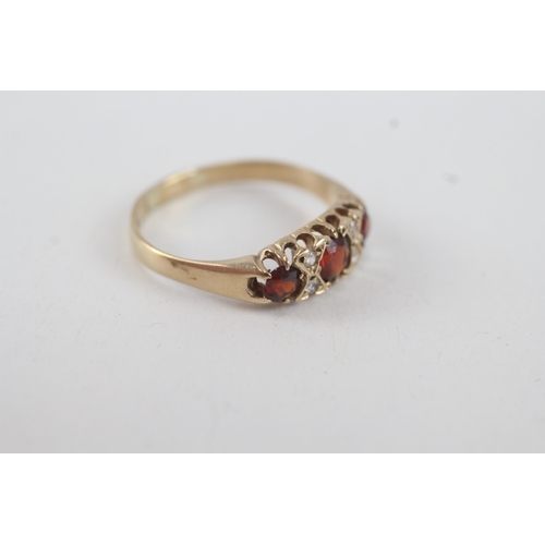 24 - 9ct gold garnet & white gemstone seven stone ring