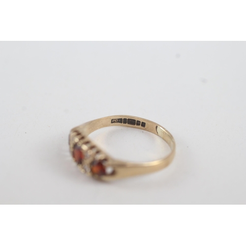 24 - 9ct gold garnet & white gemstone seven stone ring
