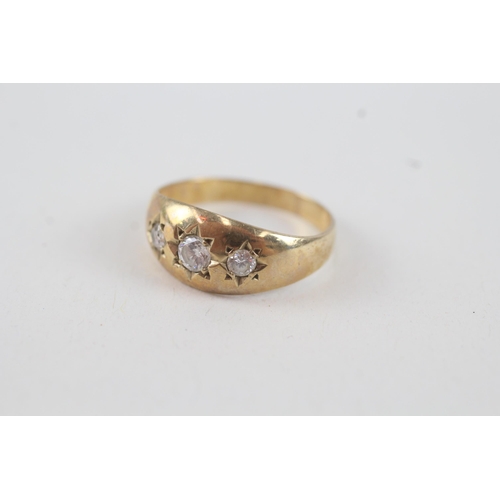 27 - 9ct gold cubic zirconia three stone ring with starburst 
motif