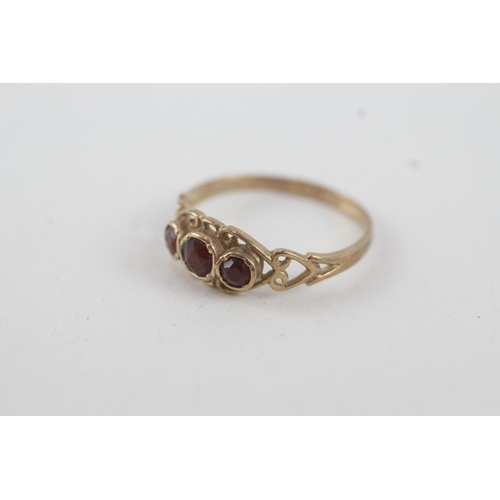 29 - 9ct gold garnet three stone ring