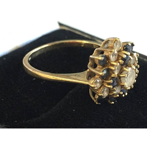 63 - 9ct Gold Sapphire Cubic Zirconia Set Cluster Ring, size P.


2055327