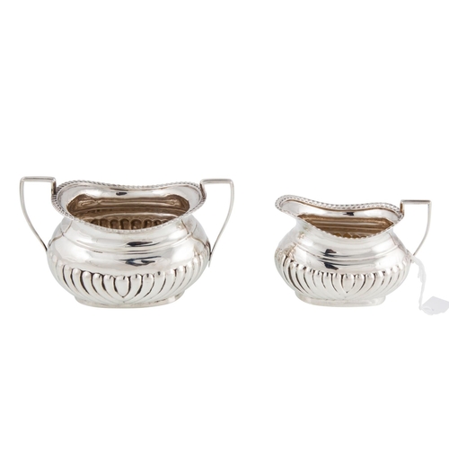 411 - A MATCHED PAIR OF GEORGE V SILVER TWIN HANDLED SUGAR BOWL and cream jug, with gadrooned decoration, ... 