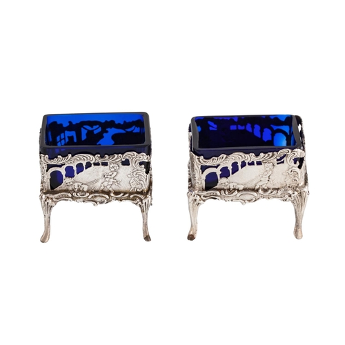 415 - AN ANTIQUE PAIR OF GERMAN HANAW (.800) SILVER SALTS, with blue glass liners, neo classical design, r... 