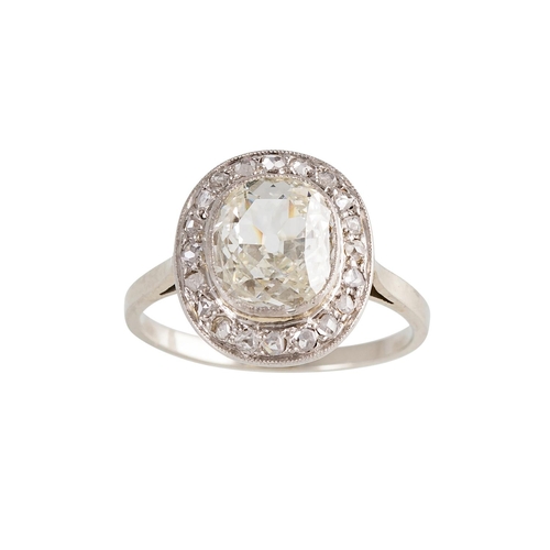 113 - AN ANTIQUE DIAMOND CLUSTER RING, the oval cushion cut diamond to an old cut diamond surround, mounte... 