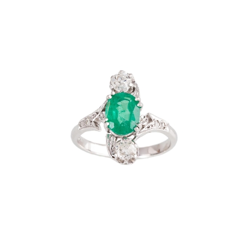 135 - AN EMERALD AND DIAMOND THREE STONE RING, of up finger design, set with an oval emerald and old cut d... 