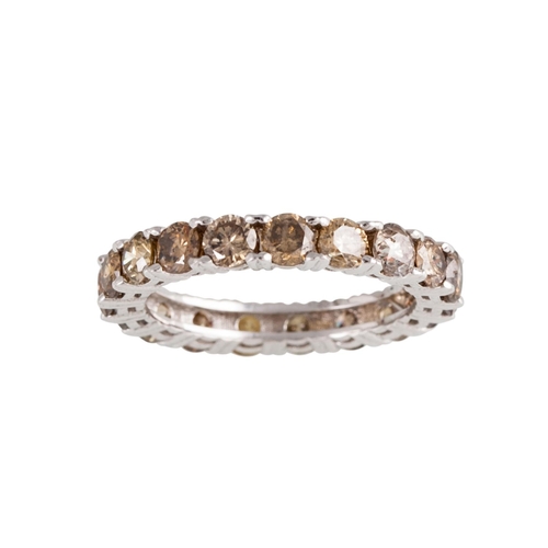 138 - A DIAMOND ETERNITY RING, set with fancy brown and yellow diamonds, mounted in white metal. Estimated... 