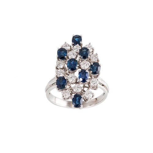 148 - A DIAMOND AND SAPPHIRE DRESS RING, of navette form, set with brilliant cut diamonds and circular sap... 