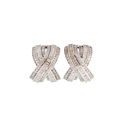 149 - A PAIR OF DIAMOND EARRINGS, of cross over design, set with baguette and brilliant cut diamonds, moun... 