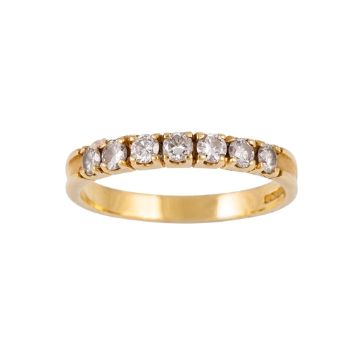 156 - A SEVEN STONE DIAMOND RING, the brilliant cut diamonds mounted in 18ct yellow gold. Estimated; weigh... 