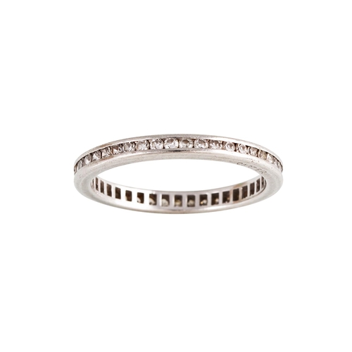 165 - A DIAMOND ETERNITY RING, the brilliant cut diamonds channel set in white metal. Estimated; weight of... 