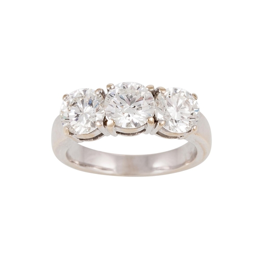 166 - A THREE STONE DIAMOND RING, the brilliant cut diamonds mounted in 18ct white gold. Estimated; weight... 