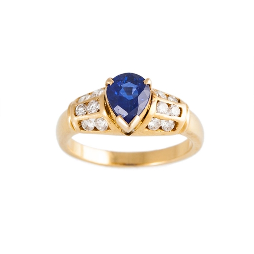 177 - A DIAMOND AND SAPPHIRE RING, the pear shaped sapphire to channel set diamond shoulders, mounted in y... 