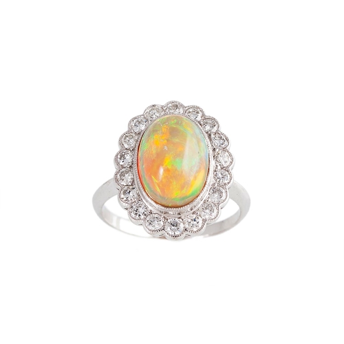 181 - AN OPAL AND DIAMOND CLUSTER RING, the cabochon opal to a brilliant cut diamond surround, mounted in ... 