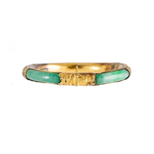 20 - A JADE BANGLE, with Chinese motifs, 14ct yellow gold mounted