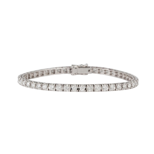 27 - A DIAMOND LINE BRACELET, the brilliant cut diamonds mounted in 18ct white gold. Estimated; weight of... 