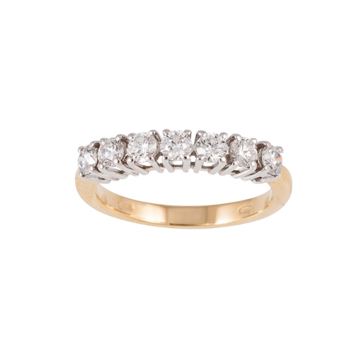 39 - A SEVEN STONE DIAMOND RING, the brilliant cut diamonds mounted in white and yellow gold. Estimated; ... 