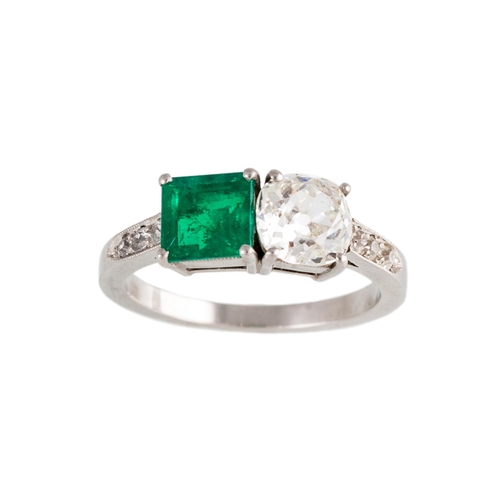 46 - AN EMERALD AND DIAMOND TWO STONE RING, set with an old cut diamond and a rectangular emerald, to dia... 