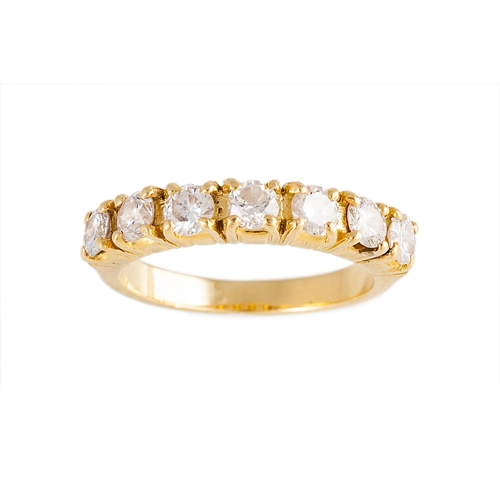 50 - A SEVEN STONE DIAMOND RING, the brilliant cut diamonds mounted in yellow gold. Estimated; weight of ... 