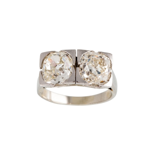 55 - AN ART DECO TWO STONE DIAMOND RING, the old cut diamonds mounted in white metal. Estimated; weight o... 