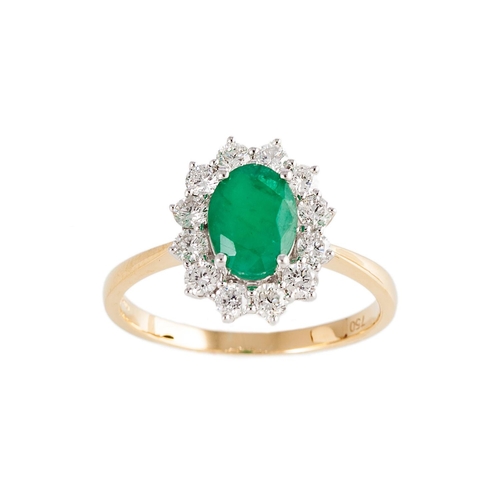 79 - A DIAMOND AND EMERALD CLUSTER RING, the oval emerald to a brilliant cut diamond surround, mounted in... 