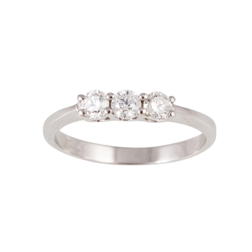 96 - A THREE STONE DIAMOND RING, the brilliant cut diamonds mounted in 18ct white gold. Estimated; weight... 