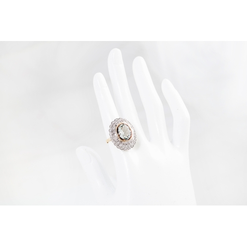 10 - A DIAMOND AND AQUAMARINE CLUSTER RING, the oval aquamarine to a two rowed circular diamond surround.... 