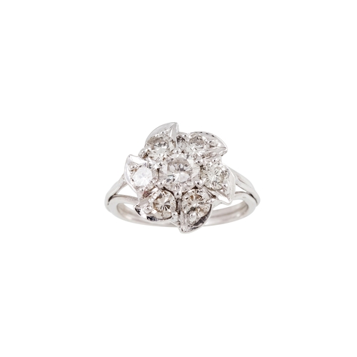 11 - A DIAMOND CLUSTER RING, the brilliant cut diamonds mounted in 18ct gold. Estimated; weight of diamon... 