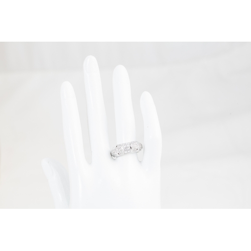 32 - A DIAMOND DRESS RING, set with a cluster of princess cut diamonds to pavé diamond shoulders, mounted... 