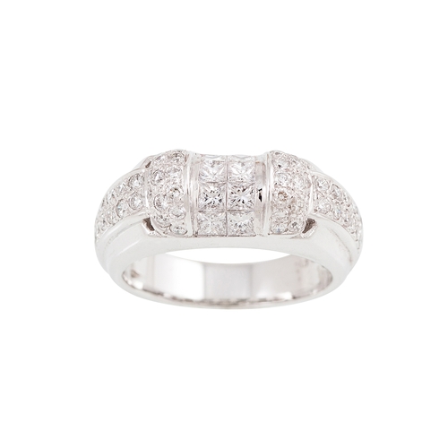 32 - A DIAMOND DRESS RING, set with a cluster of princess cut diamonds to pavé diamond shoulders, mounted... 