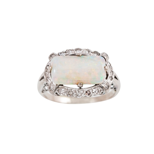 42 - A VINTAGE OPAL AND DIAMOND CLUSTER RING, the rectangular opal to an eight cut diamond surround, moun... 