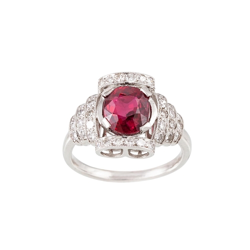 247 - A RUBY AND DIAMOND CLUSTER RING, in the Art Deco style, the oval ruby to a diamond surround and shou... 