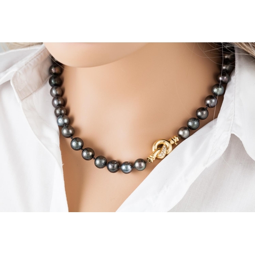 105 - A CULTURED PEARL NECKLACE, the graduating grey tones pearls to an 18ct gold diamond set clasp