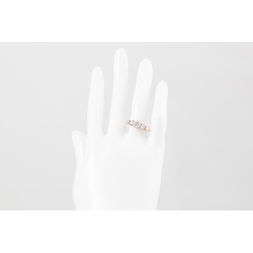 119 - A FIVE STONE DIAMOND RING, the graduated brilliant cut diamonds mounted in yellow gold. Estimated we... 