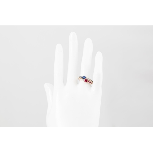 120 - A CROSS OVER DRESS RING, mounted with sapphire, ruby and diamonds, the oval stones to channel set sh... 