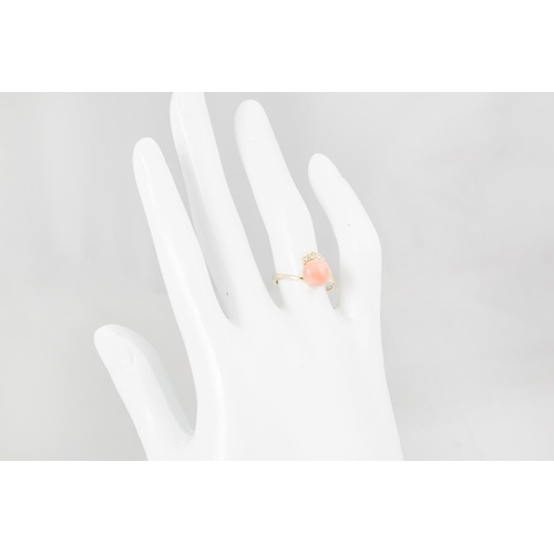 163 - A CORAL AND DIAMOND RING, of twist design, mounted in 14ct yellow gold, size L - M