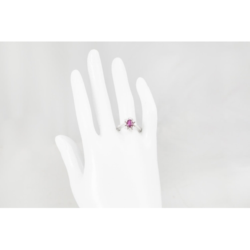 168 - A RUBY AND DIAMOND CLUSTER RING, the oval ruby to a brilliant cut diamond surround, mounted in 14ct ... 