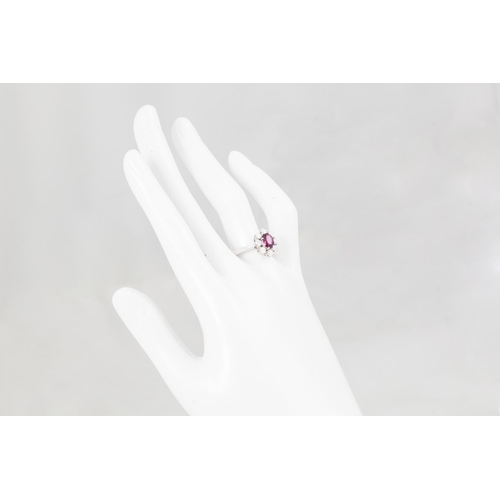 168 - A RUBY AND DIAMOND CLUSTER RING, the oval ruby to a brilliant cut diamond surround, mounted in 14ct ... 