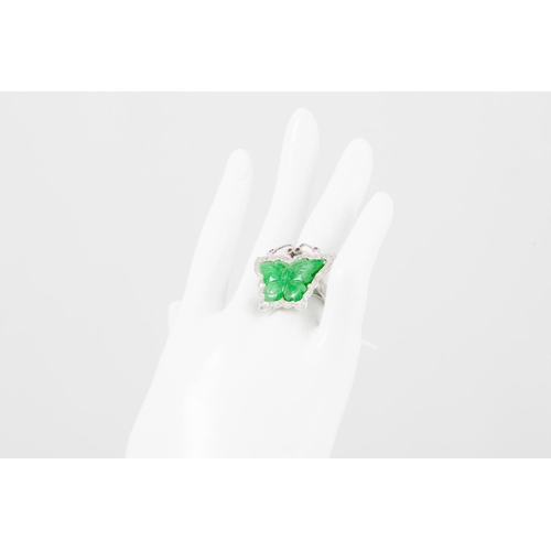 187 - A DIAMOND AND JADE RING, modelled as a butterfly, the carved jade wings to ruby eyes and a diamond s... 