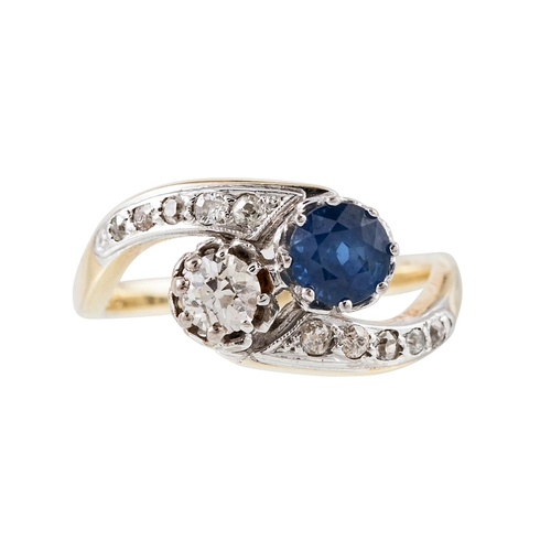 202 - A DIAMOND AND SAPPHIRE CROSS OVER RING, mounted in 14ct yellow gold, size O.