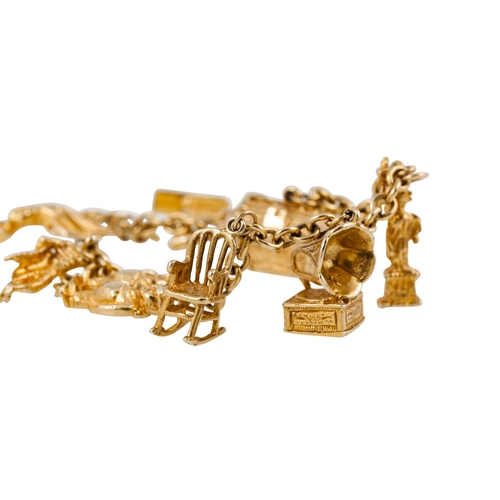 217 - A 10CT YELLOW GOLD CHARM BRACELET with eight 10ct yellow gold charms attached 36 g.