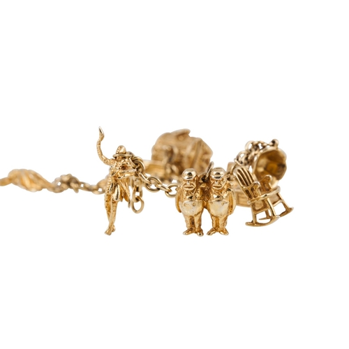 217 - A 10CT YELLOW GOLD CHARM BRACELET with eight 10ct yellow gold charms attached 36 g.