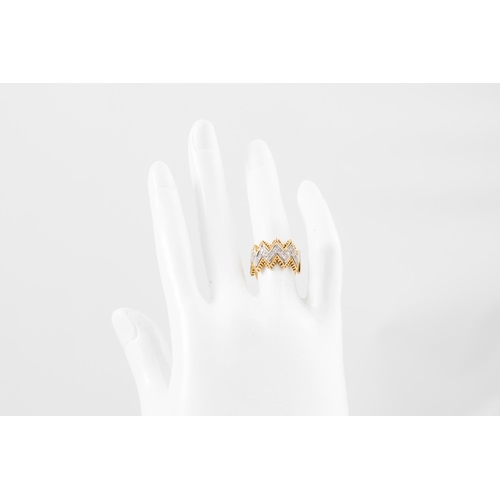 221 - A DIAMOND DRESS RING, of shaped form, mounted in 18ct white and yellow gold, size J