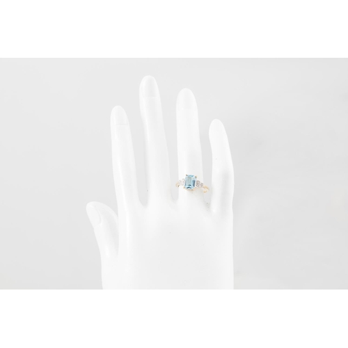 230 - A BLUE TOPAZ AND DIAMOND RING, the rectangular stone to stepped diamond shoulders, mounted in yellow... 