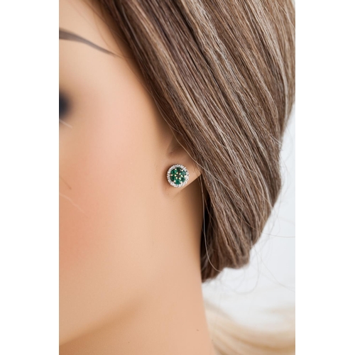 232 - A PAIR OF EMERALD AND DIAMOND CLUSTER EARRINGS, of circular form, mounted in white gold