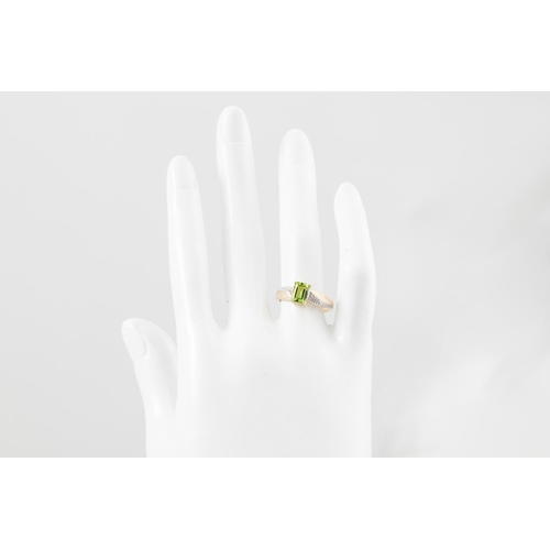 242 - A PERIDOT AND DIAMOND RING, mounted in gold, size L - M.